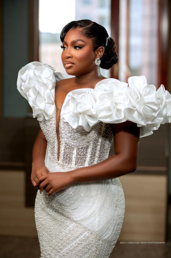 Bride in a white beaded gown with floral shoulders