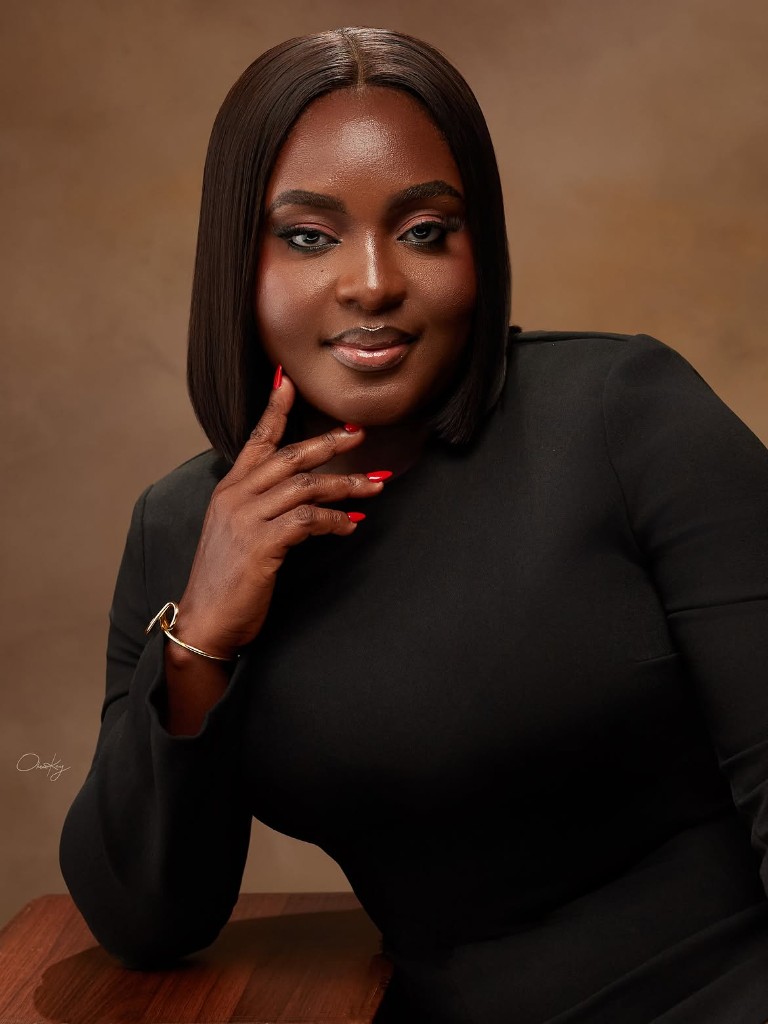 Shulamite, founder and lead makeup artist, in a black dress
