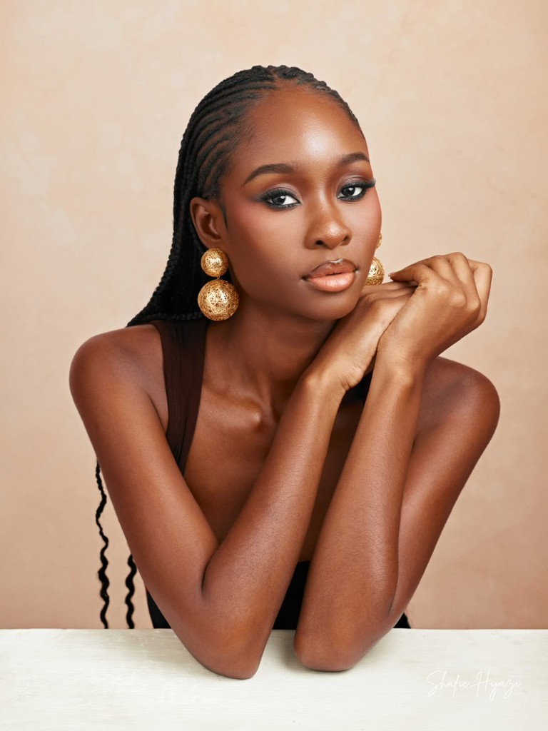 Editorial portrait with gold earrings and braids